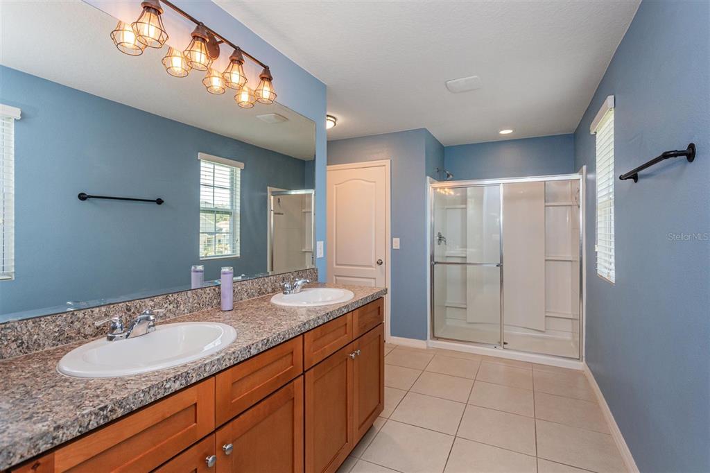 2470 Valhalla Drive Tavares, FL 32778 - Photo 17 of 26 a spacious bathroom with a granite countertop sink a mirror and a shower