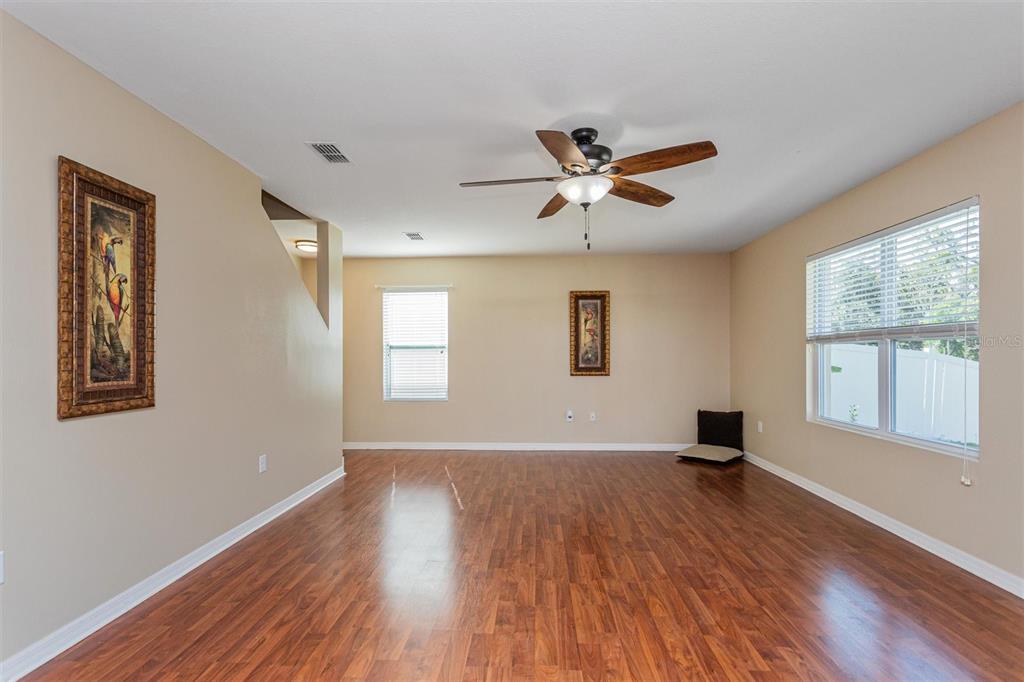 2470 Valhalla Drive Tavares, FL 32778 - Photo 6 of 26 a view of an empty room with a window and wooden floor
