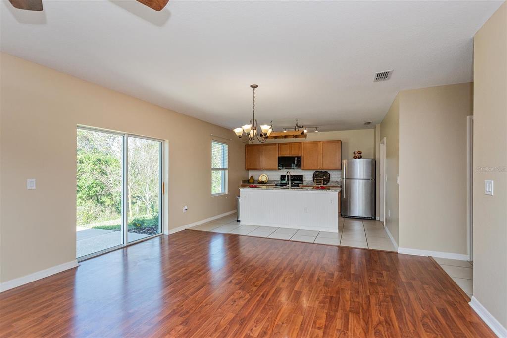 2470 Valhalla Drive Tavares, FL 32778 - Photo 7 of 26 a view of a kitchen with microwave and wooden floor