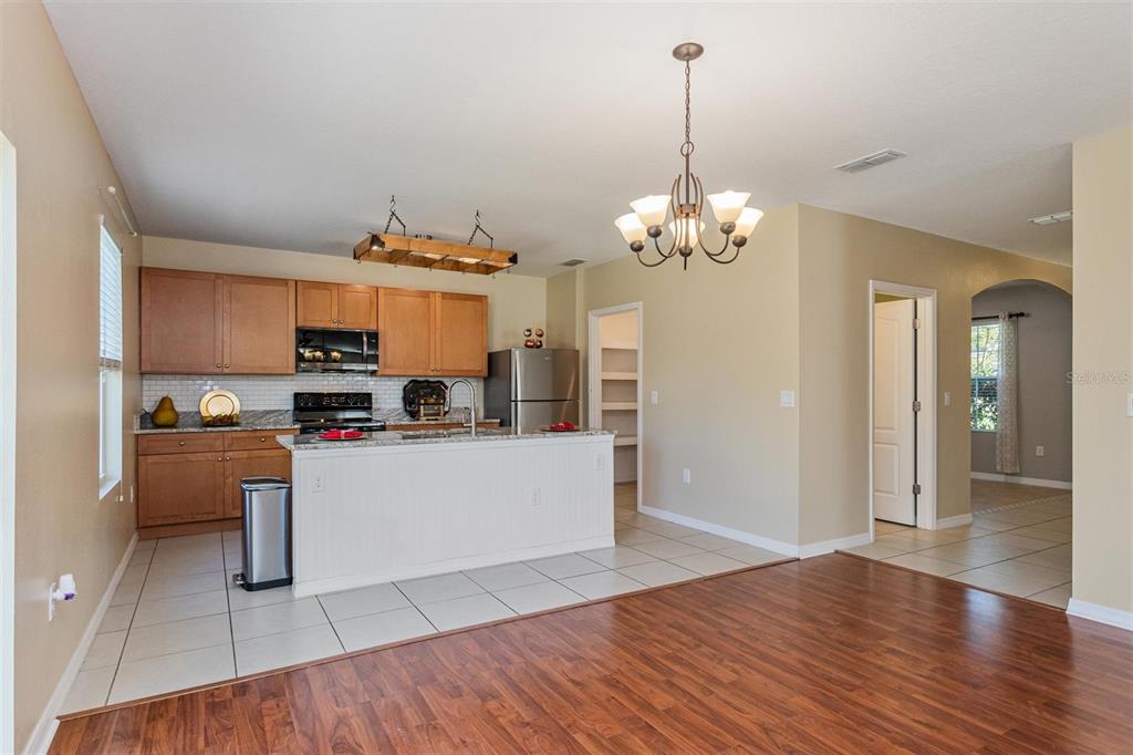 2470 Valhalla Drive Tavares, FL 32778 - Photo 8 of 26 a living room with kitchen island granite countertop furniture and a chandelier