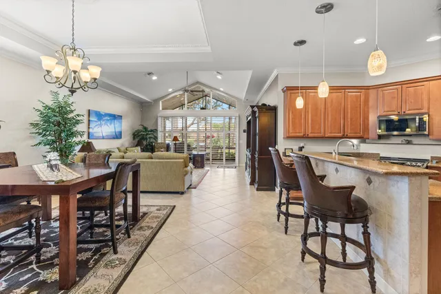 a large white kitchen with a stove a sink dishwasher and a refrigerator with wooden cabinets