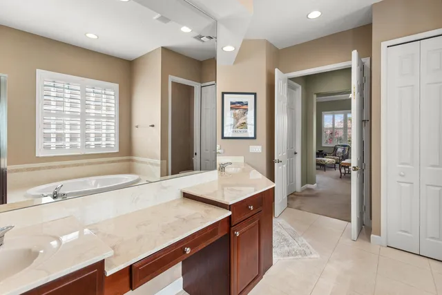 a tennis court that has trees in front of it