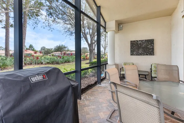 a view of a swimming pool with a table and chairs under an umbrella