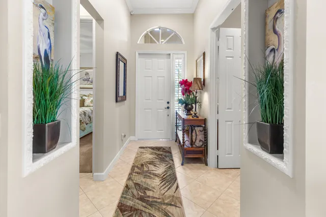 a view of a brick house next to a yard with big trees