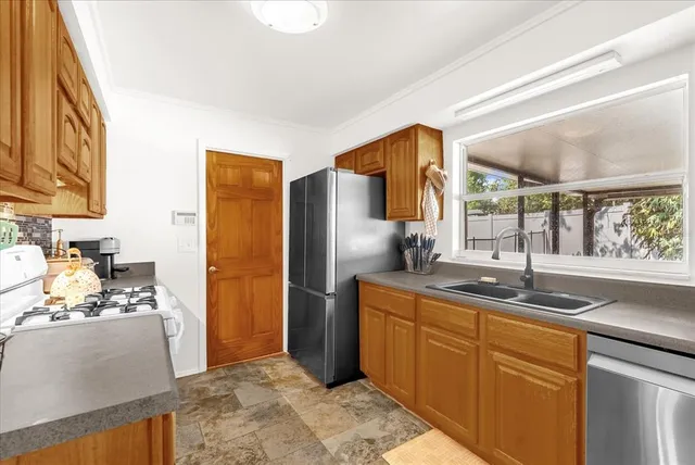 a kitchen with a stove and a refrigerator