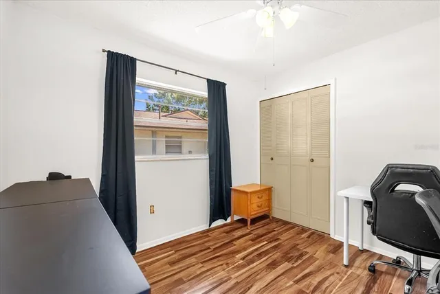 a view of a workspace with furniture and wooden floor