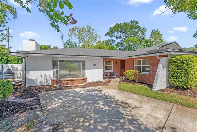 a front view of a house with a garden and patio