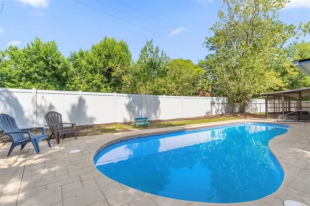 an aerial view of residential houses with outdoor space and street view