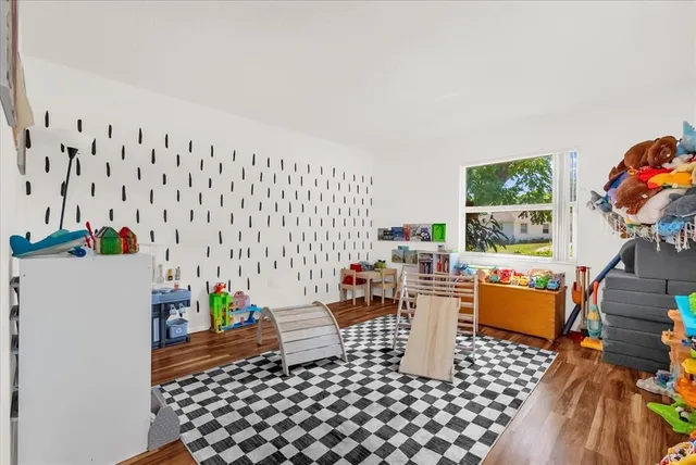 a room with furniture a rug and a window