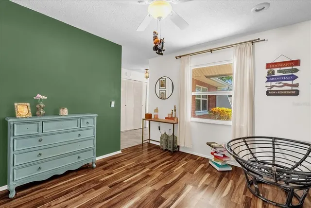 a living room with furniture a fireplace and a large window
