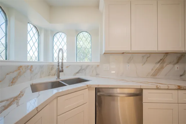 a kitchen with a sink and cabinets