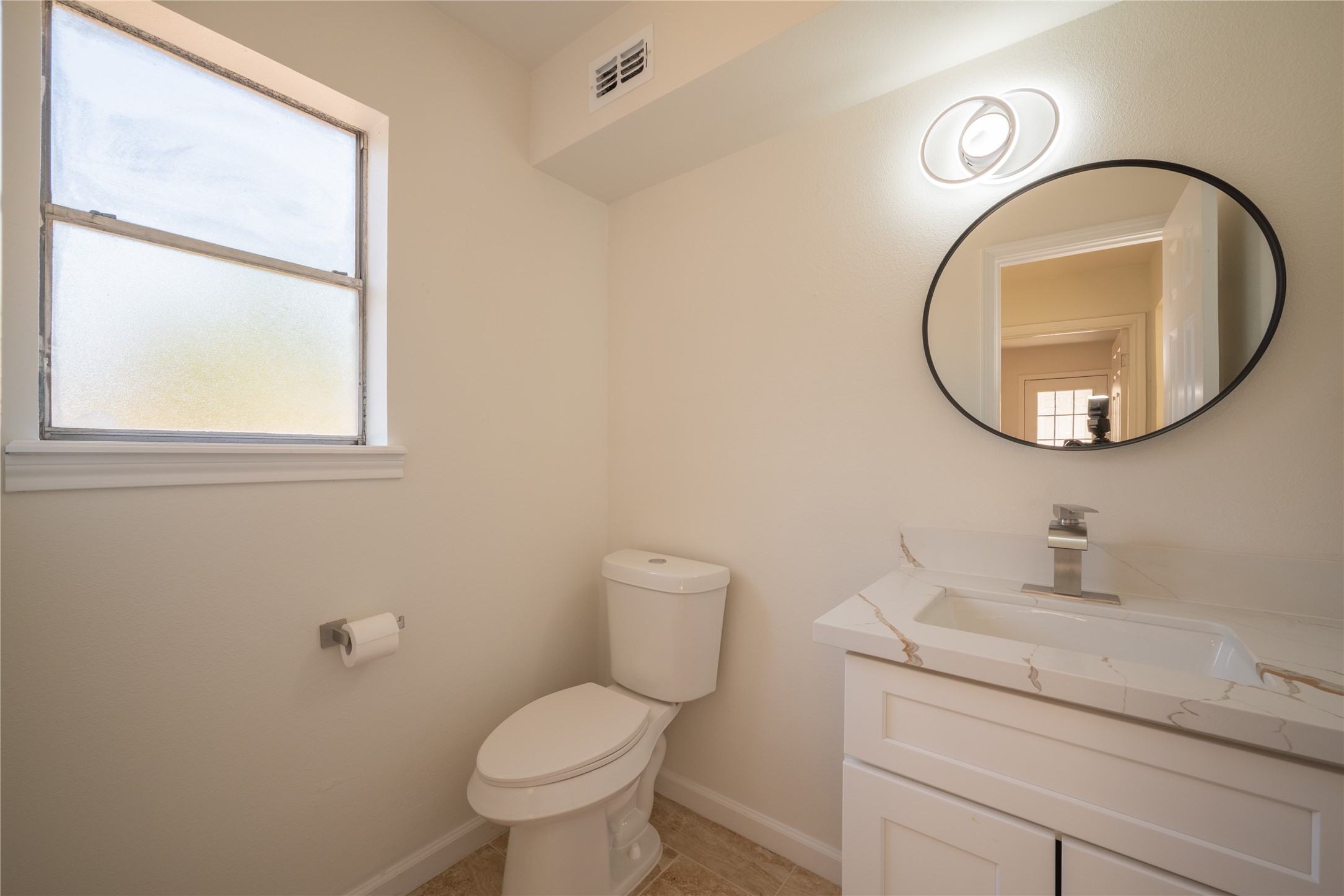 1923 Big Horn Drive Houston, TX 77090 - Photo 20 of 48 a bathroom with a toilet a sink and a mirror