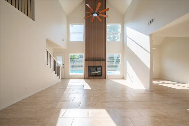a view of a livingroom with an empty space and a fireplace