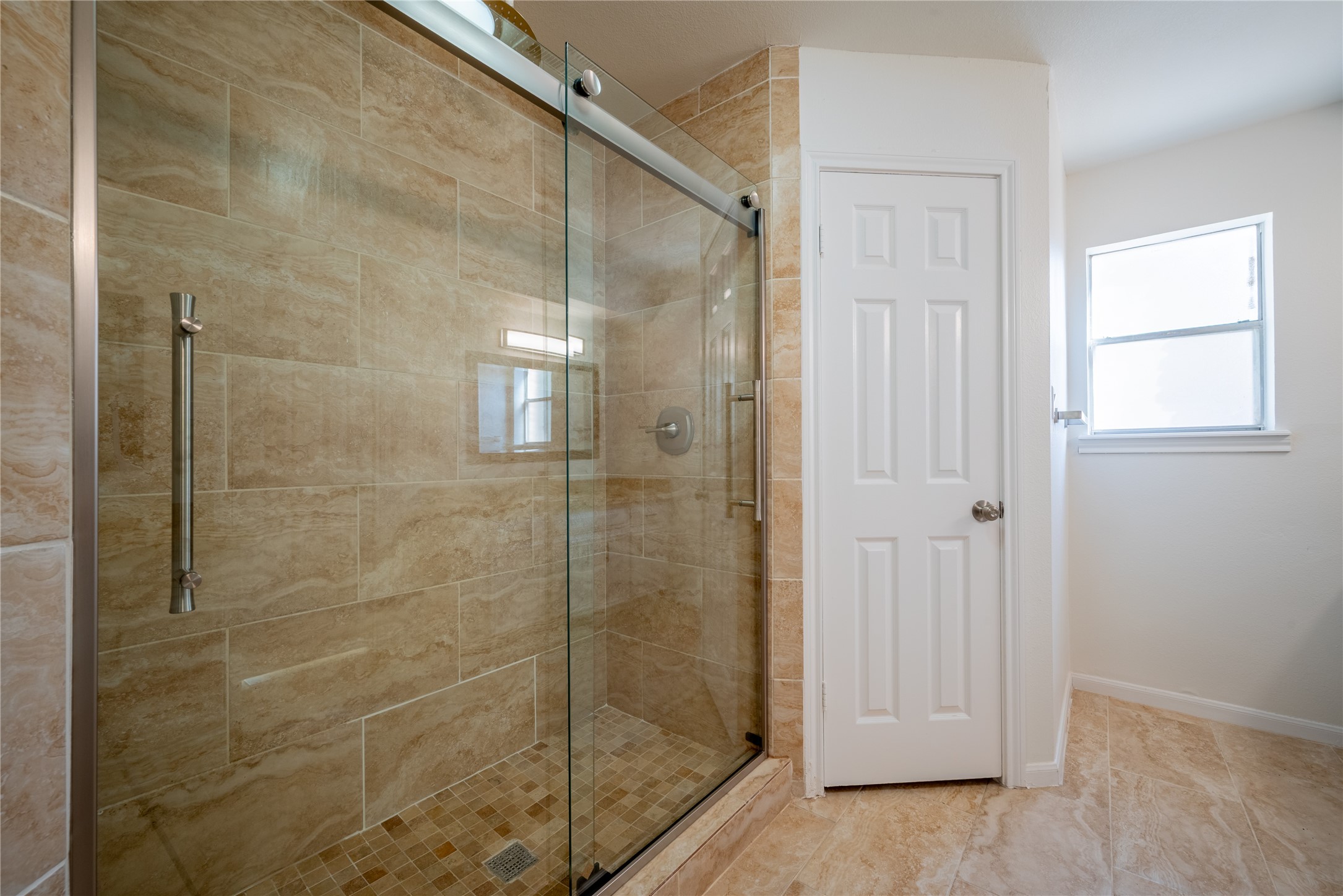 1923 Big Horn Drive Houston, TX 77090 - Photo 30 of 48 a bathroom with a glass shower door