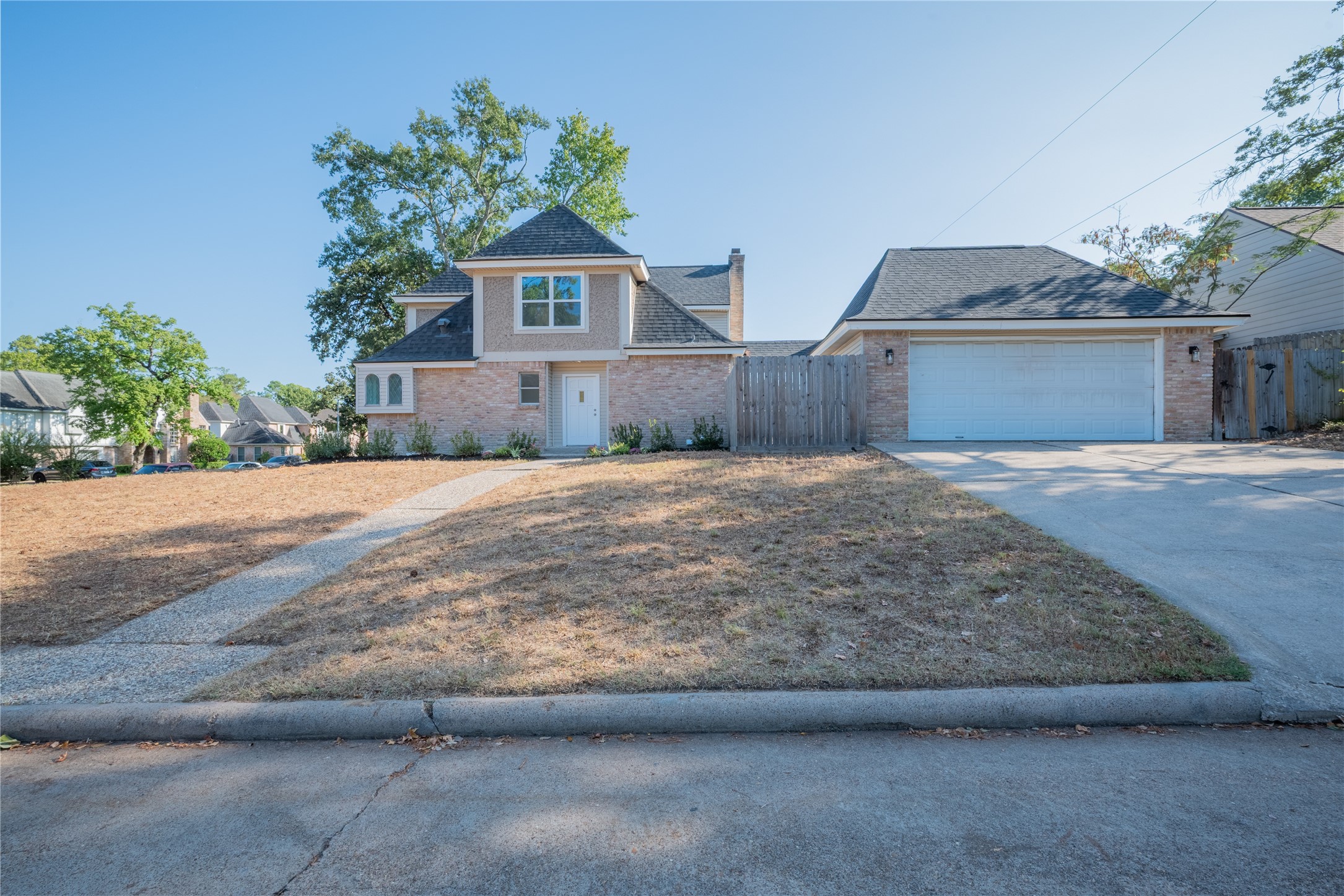 1923 Big Horn Drive Houston, TX 77090 - Photo 3 of 48 a front view of house with yard and trees in the background