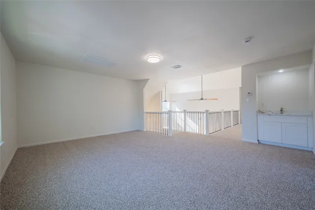 a view of a kitchen with white cabinets