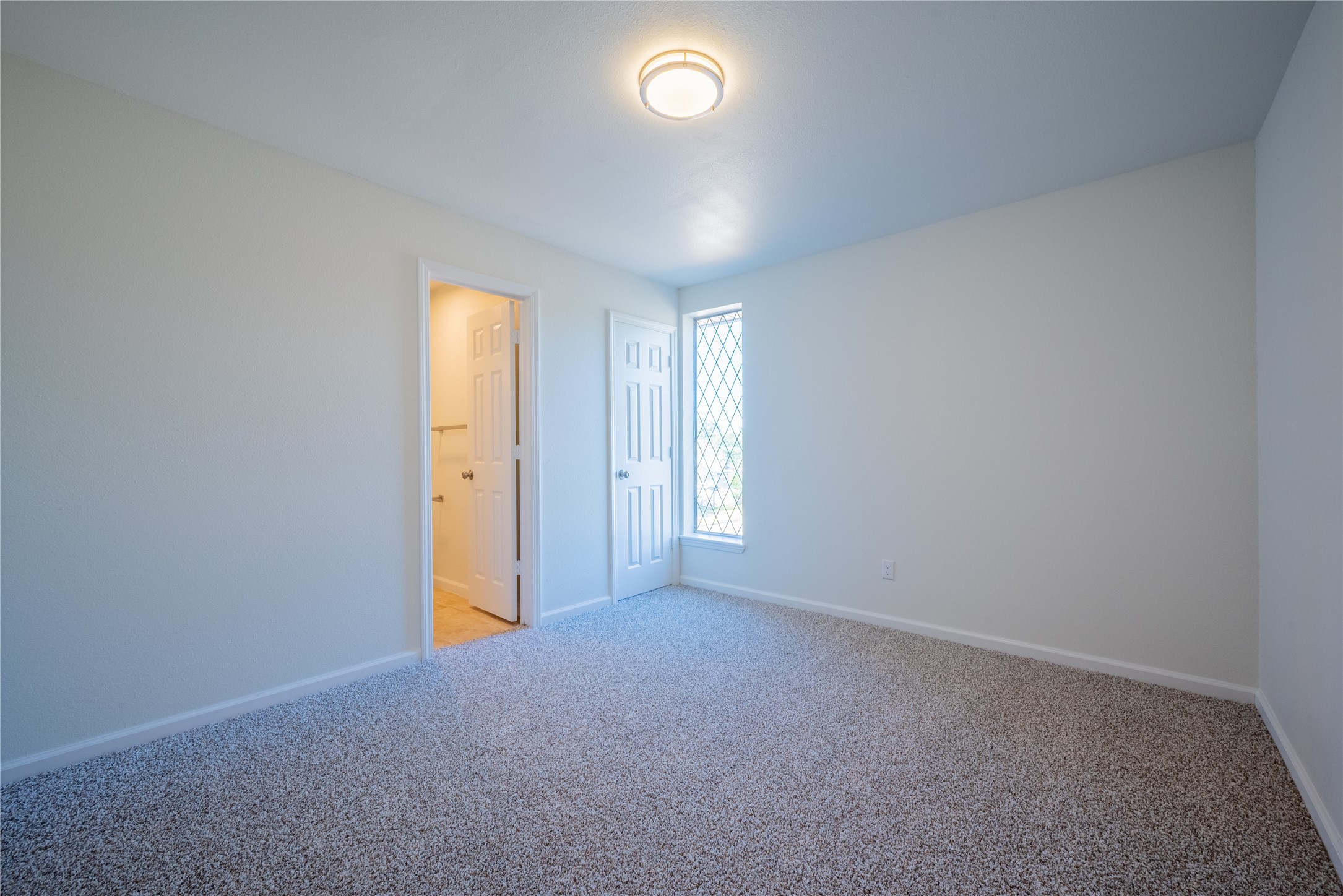 1923 Big Horn Drive Houston, TX 77090 - Photo 39 of 48 an empty room with windows and closet