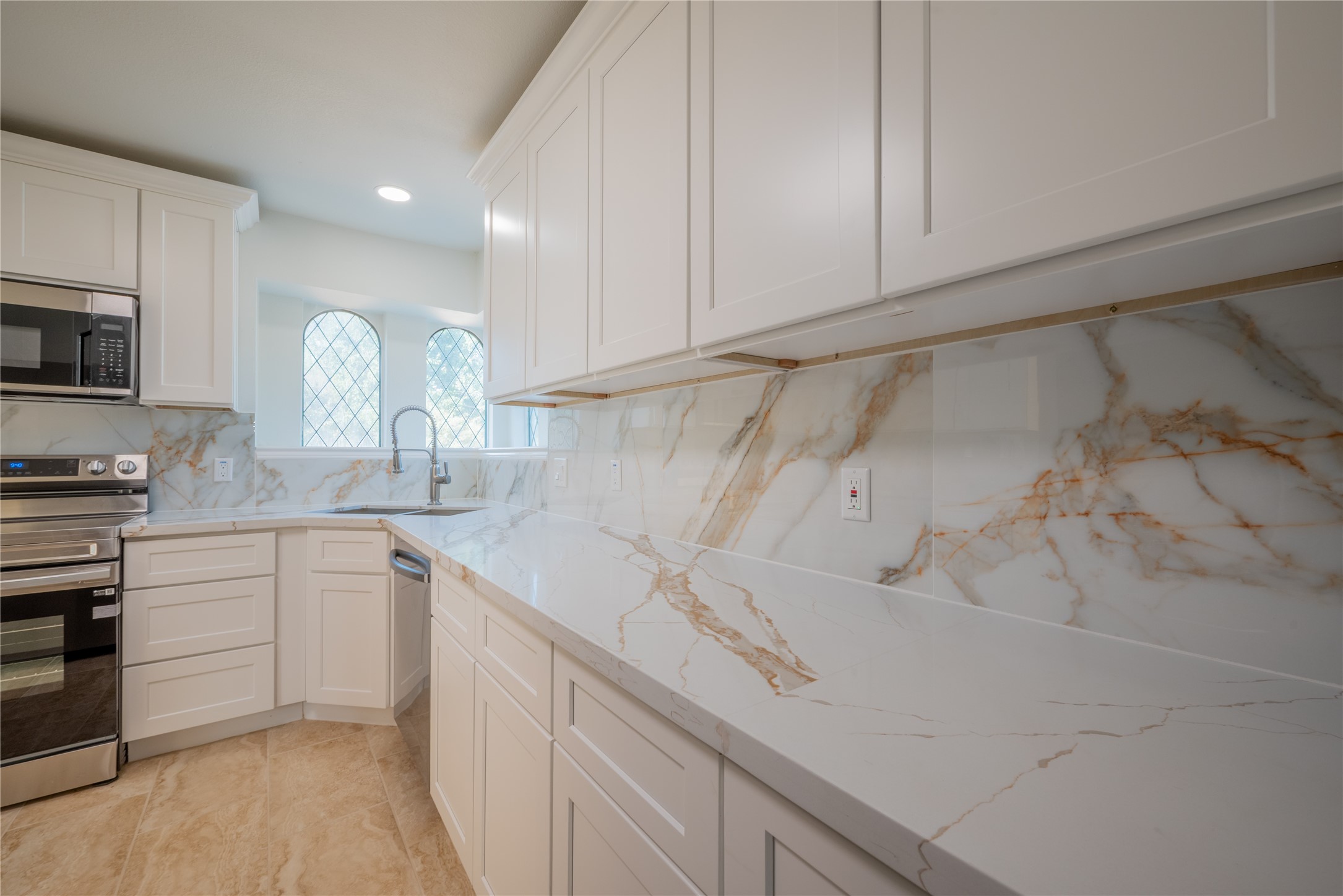 1923 Big Horn Drive Houston, TX 77090 - Photo 9 of 48 a kitchen with a sink cabinets and stainless steel appliances