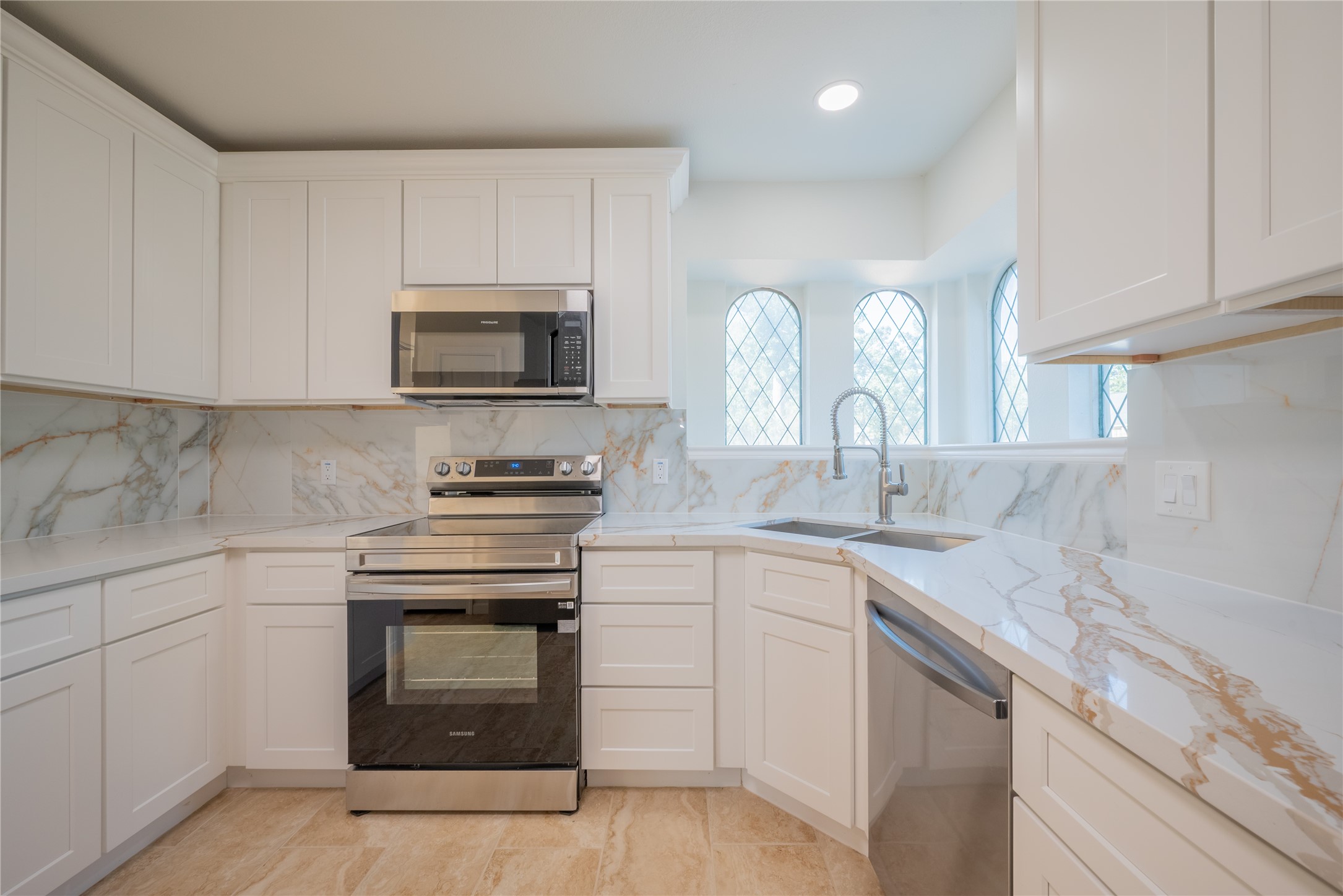 1923 Big Horn Drive Houston, TX 77090 - Photo 10 of 48 a kitchen with appliances a sink and cabinets