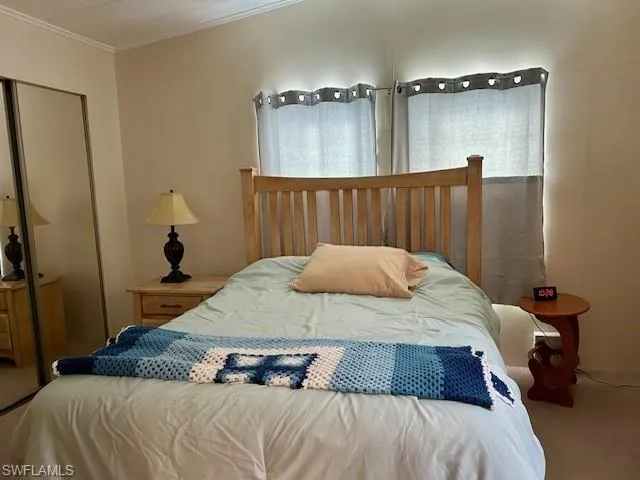 a bedroom with a bed and a large mirror