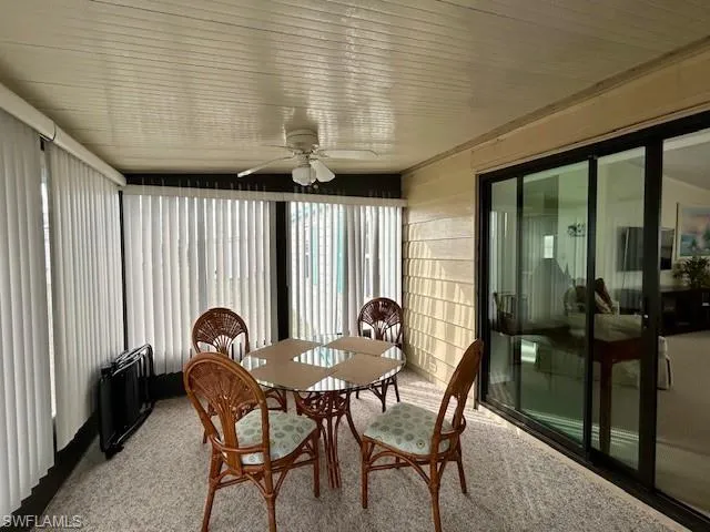 a view of a dining room with furniture and window