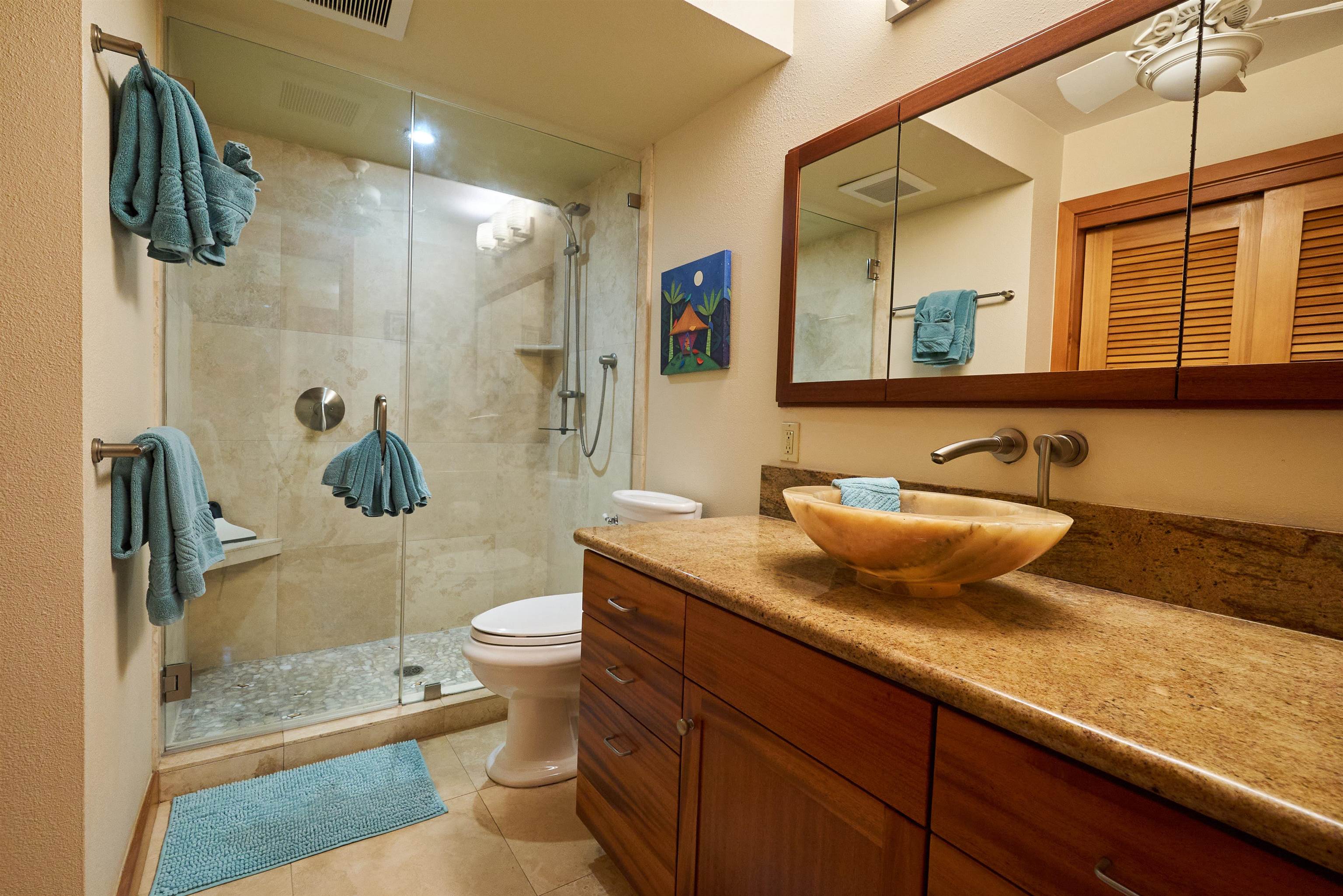2994 South Kihei Road, Unit 203 Kihei, HI 96753 - Photo 13 of 28 a bathroom with a granite countertop sink a toilet a mirror and shower