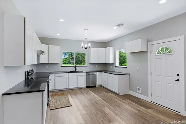 a kitchen with a sink a counter space cabinets and stainless steel appliances