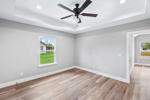 wooden floor in an empty room with a window