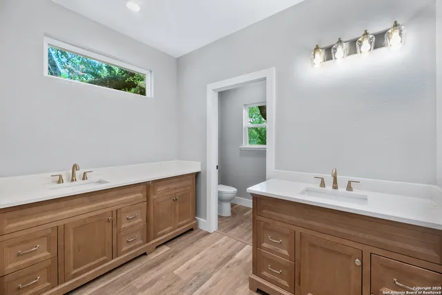 a bathroom with a double vanity sink and a mirror