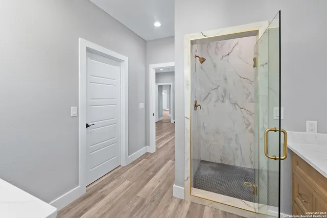 a bathroom with a shower and a glass door