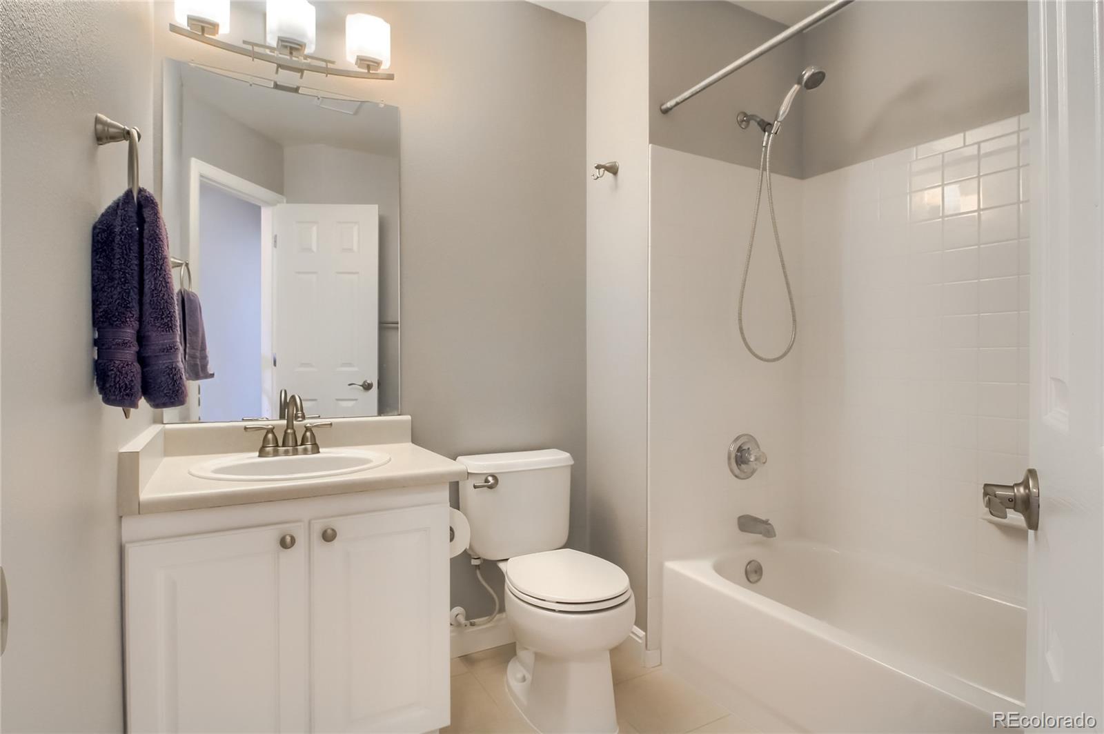 1031 Timbervale Trail Highlands Ranch, CO 80129 - Photo 23 of 34 a bathroom with a sink toilet vanity and shower