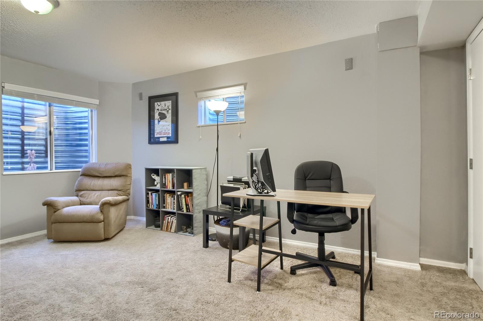 1031 Timbervale Trail Highlands Ranch, CO 80129 - Photo 26 of 34 a living room with furniture and a fireplace