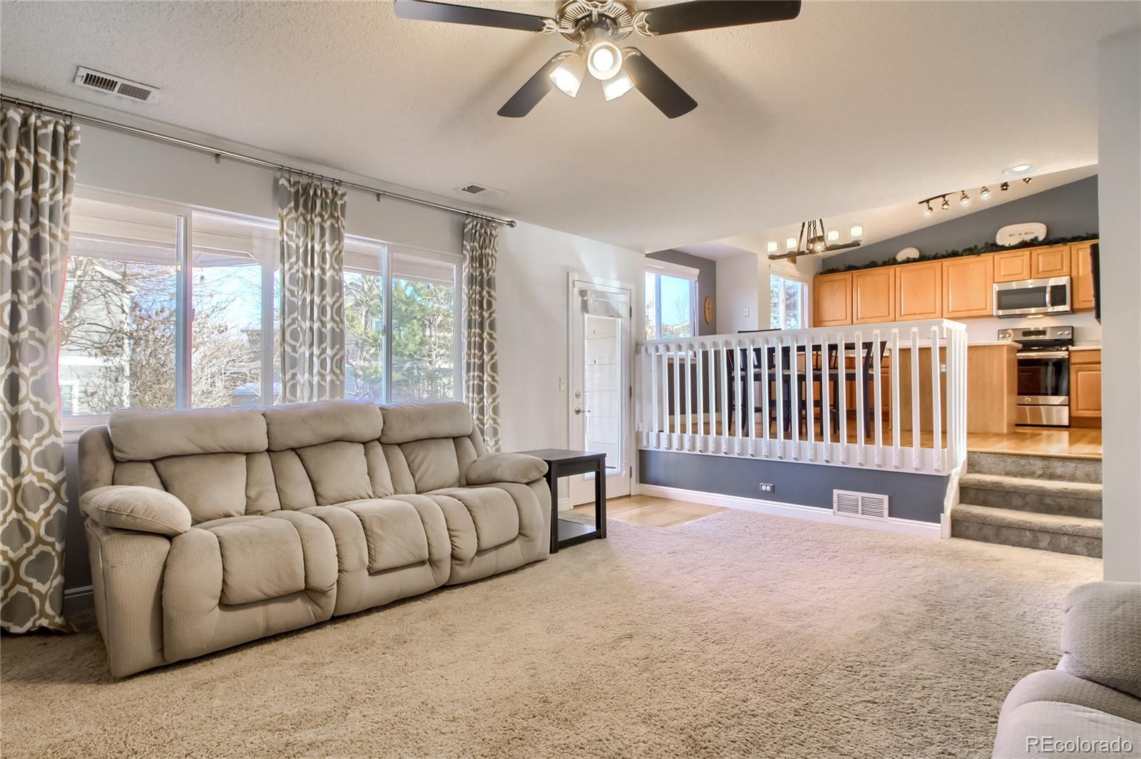 1031 Timbervale Trail Highlands Ranch, CO 80129 - Photo 7 of 34 a living room with furniture and a large window