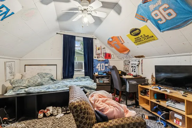 a bedroom with a bed and flat screen tv