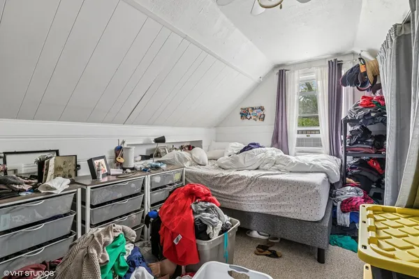 a bedroom with bed and a window