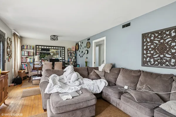 a living room with furniture a flat screen tv and a large window