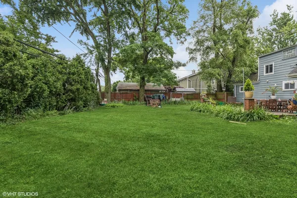 a view of house with backyard