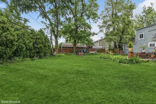 a view of house with backyard