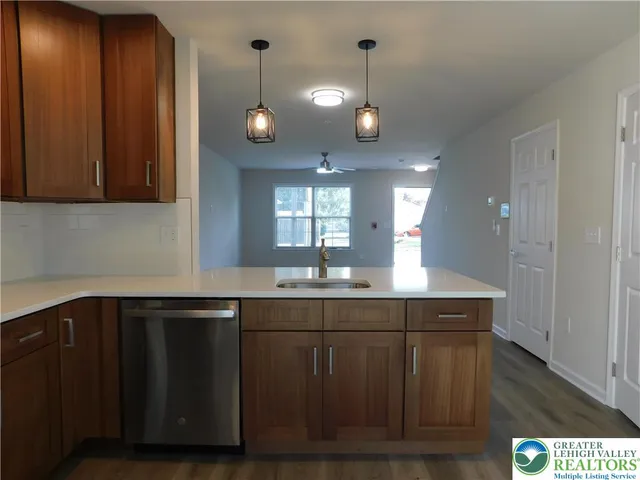 a kitchen with a sink cabinets and wooden floor