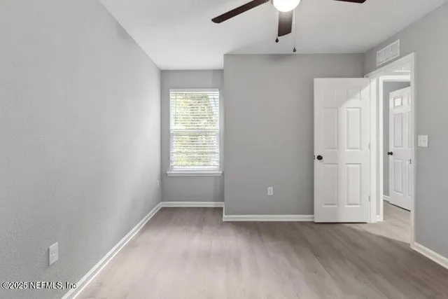 an empty room with windows and closet