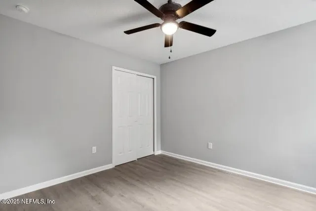 an empty room with ceiling fan