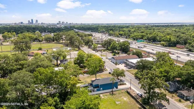 an aerial view of residential houses with outdoor space and lake view