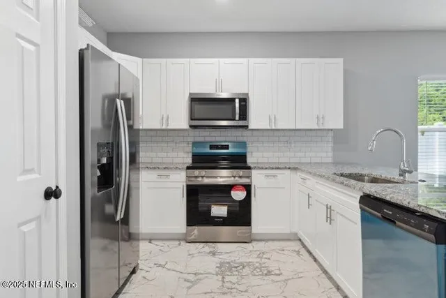 a kitchen with a refrigerator stove and microwave