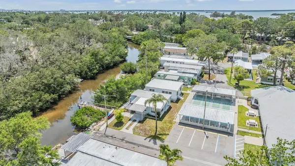 an aerial view of a house with a yard and lake view