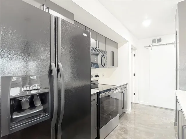 a bathroom with a sink toilet vanity and shower