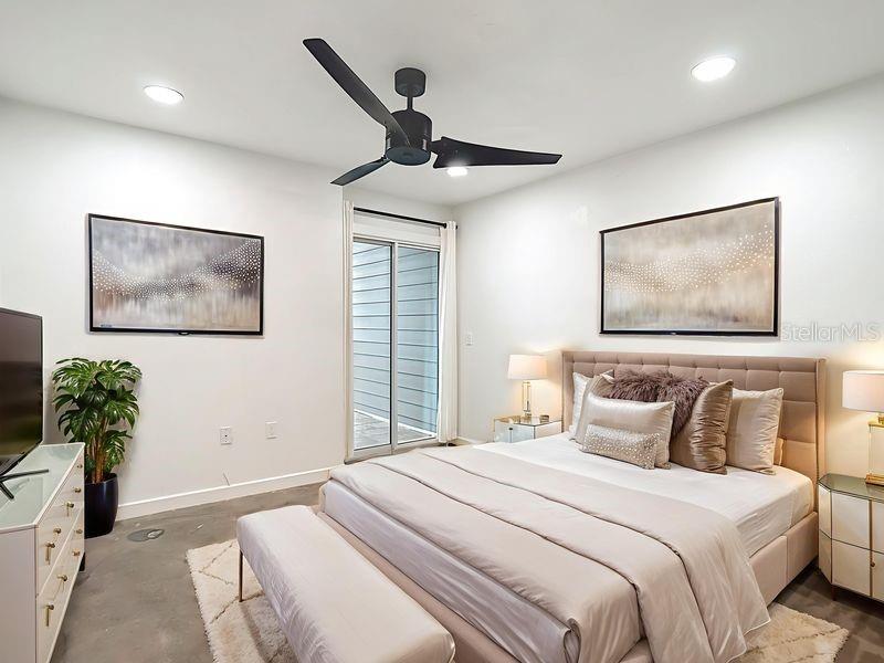 5722 Biscayne Court, Unit 103 New Port Richey, FL 34652 - Photo 23 of 99 a bedroom with a bed and a painting on the wall