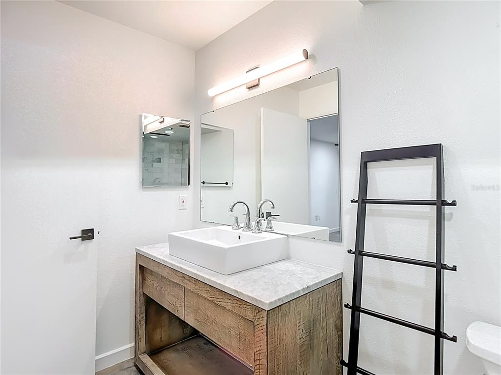 5722 Biscayne Court, Unit 103 New Port Richey, FL 34652 - Photo 27 of 99 a bathroom with a sink and a mirror