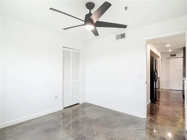a view of a house with a big yard plants and large trees