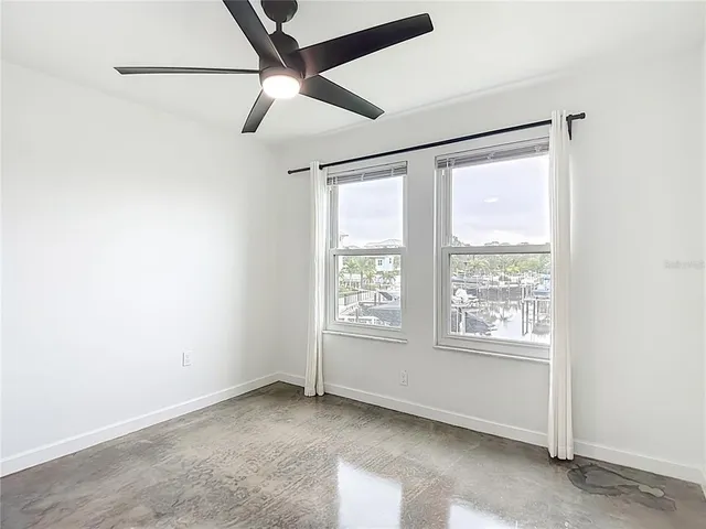 a view of a house with a yard and potted plants