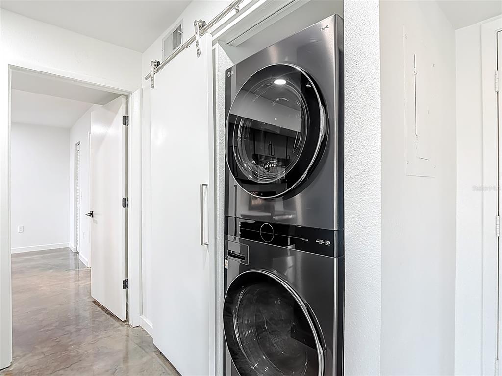 5722 Biscayne Court, Unit 103 New Port Richey, FL 34652 - Photo 34 of 99 a close view of a utility room with dryer and washer